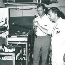 Dr. Daniel Verne hands phone to Kim Kaiser after talking to Washington, DC/